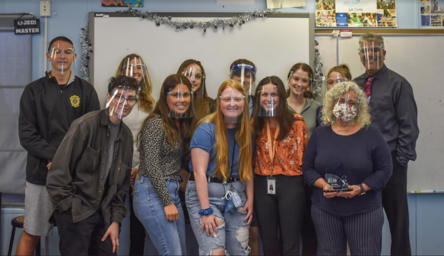 The Wave staff including the former Editor in Chief, Cassandra Scalia, stand together with Val Simon after presenting an award. 