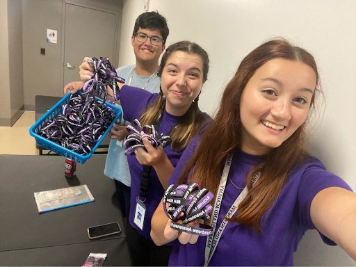 Key Club officers Tyler Clifford, Taylor Drott, and Makayla Hendrick sell bracelets to help raise money for Wynnes Warriors.