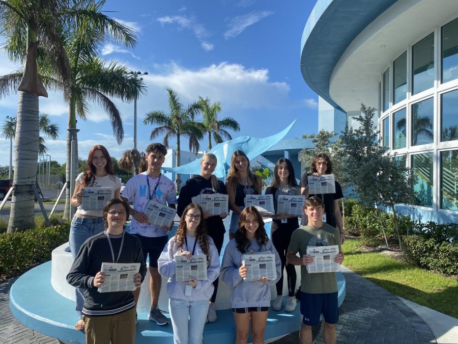 Wave staff pose with their print newspaper. Photo credit: Wave Staff