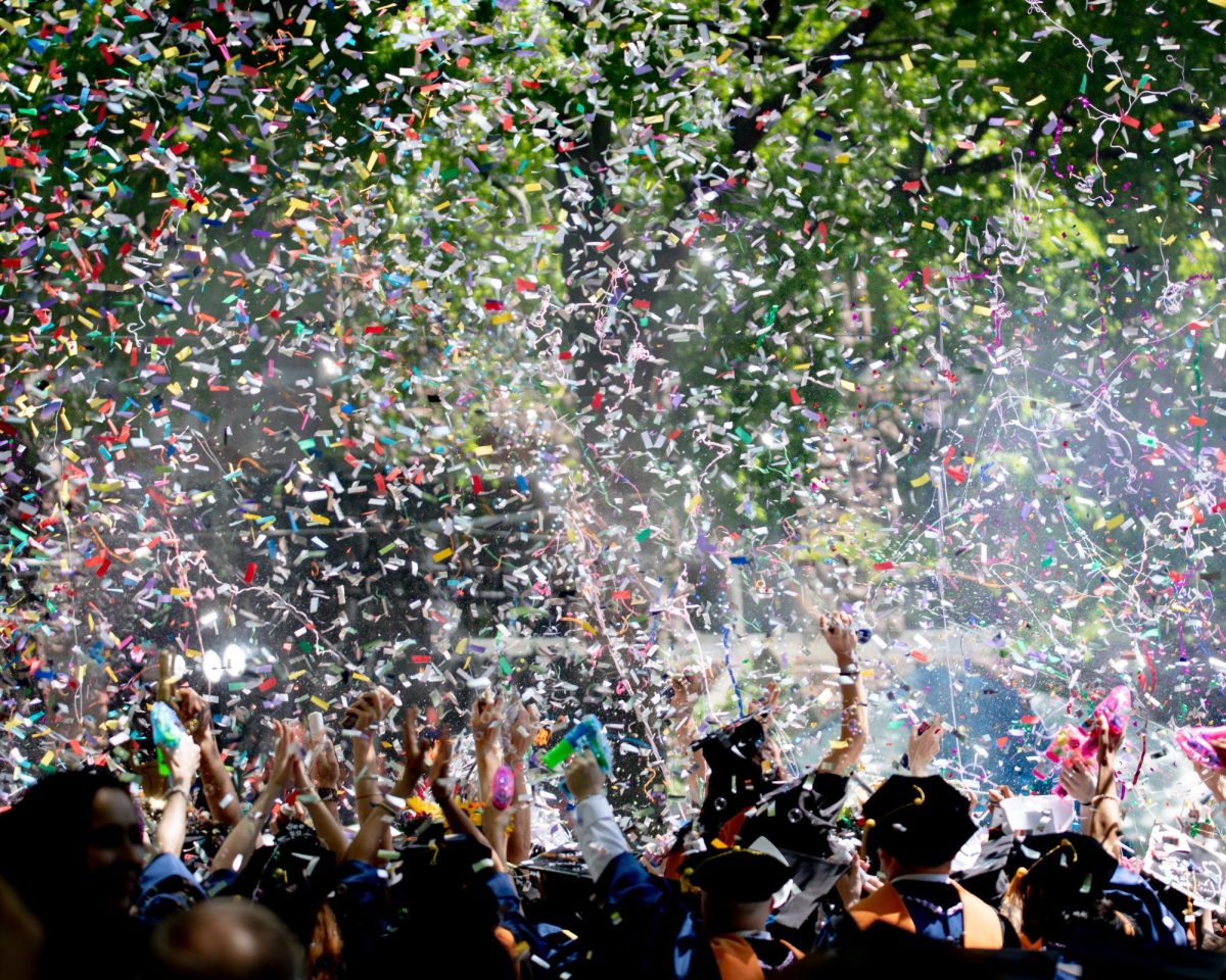 [Unsplash] A crowd parties under as confetti pours down through the air.