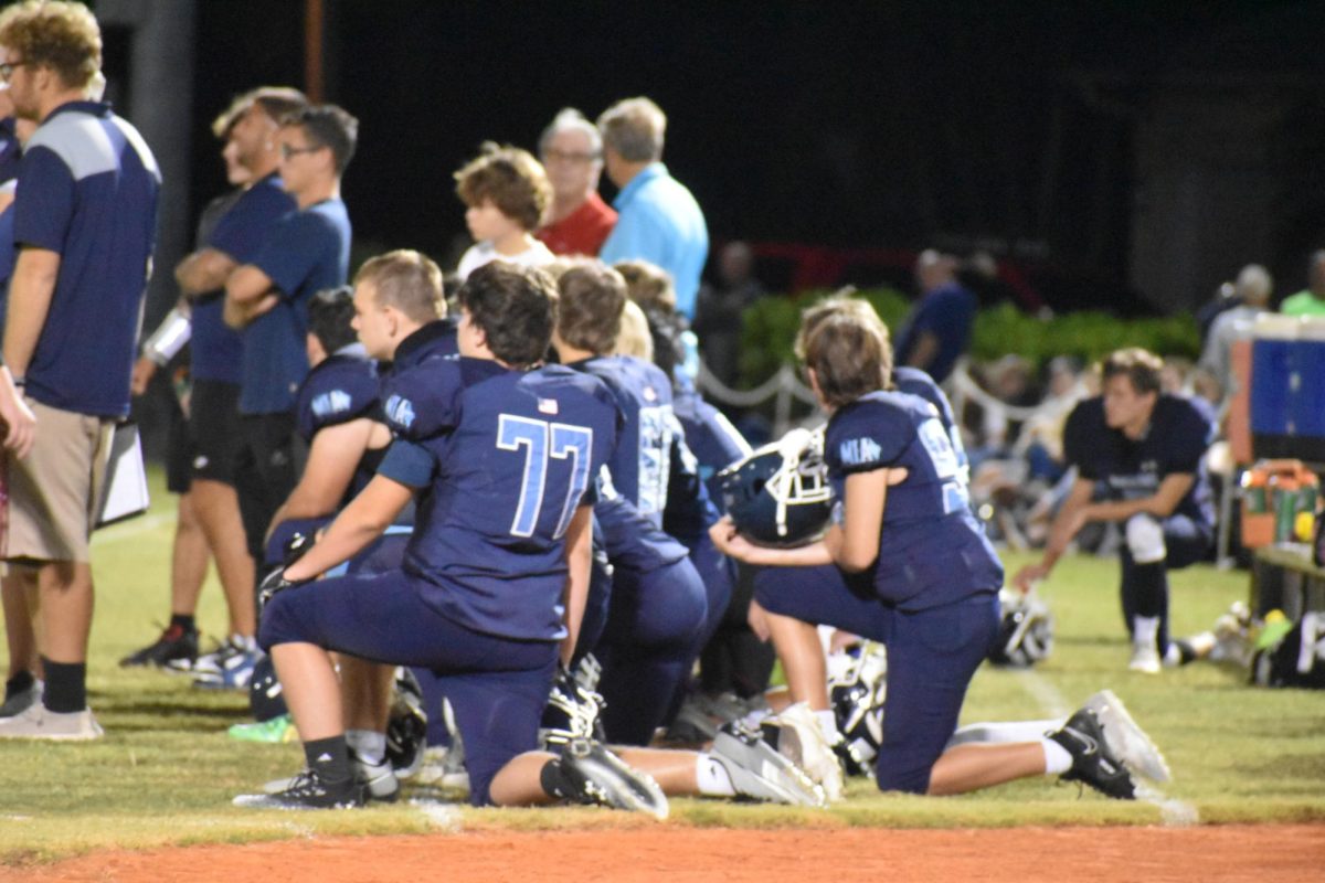 MIA football players taking a knee during the homecoming game. 