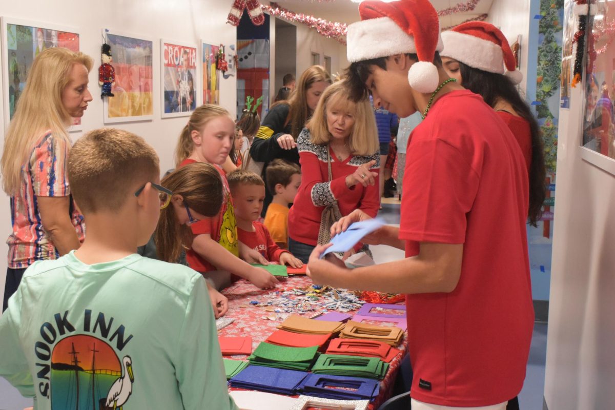 Freshman Gabe Polanco helping many children with arts and crafts.