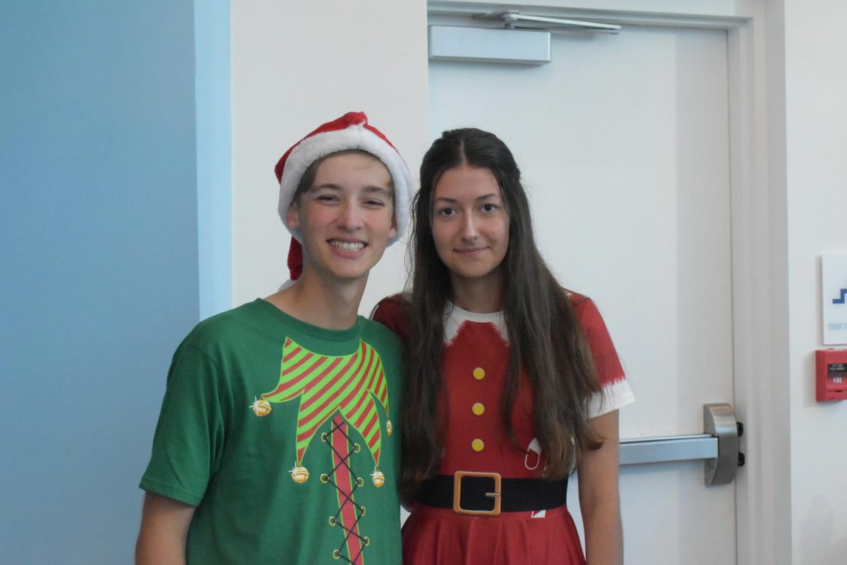 Austin Hendrick and Celine Schauer posing for a picture dressed festively.  