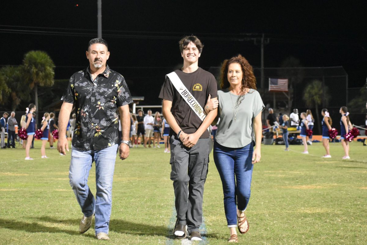 Sophomore homecoming court, Joseph Padilla being accompanied by his parents. 