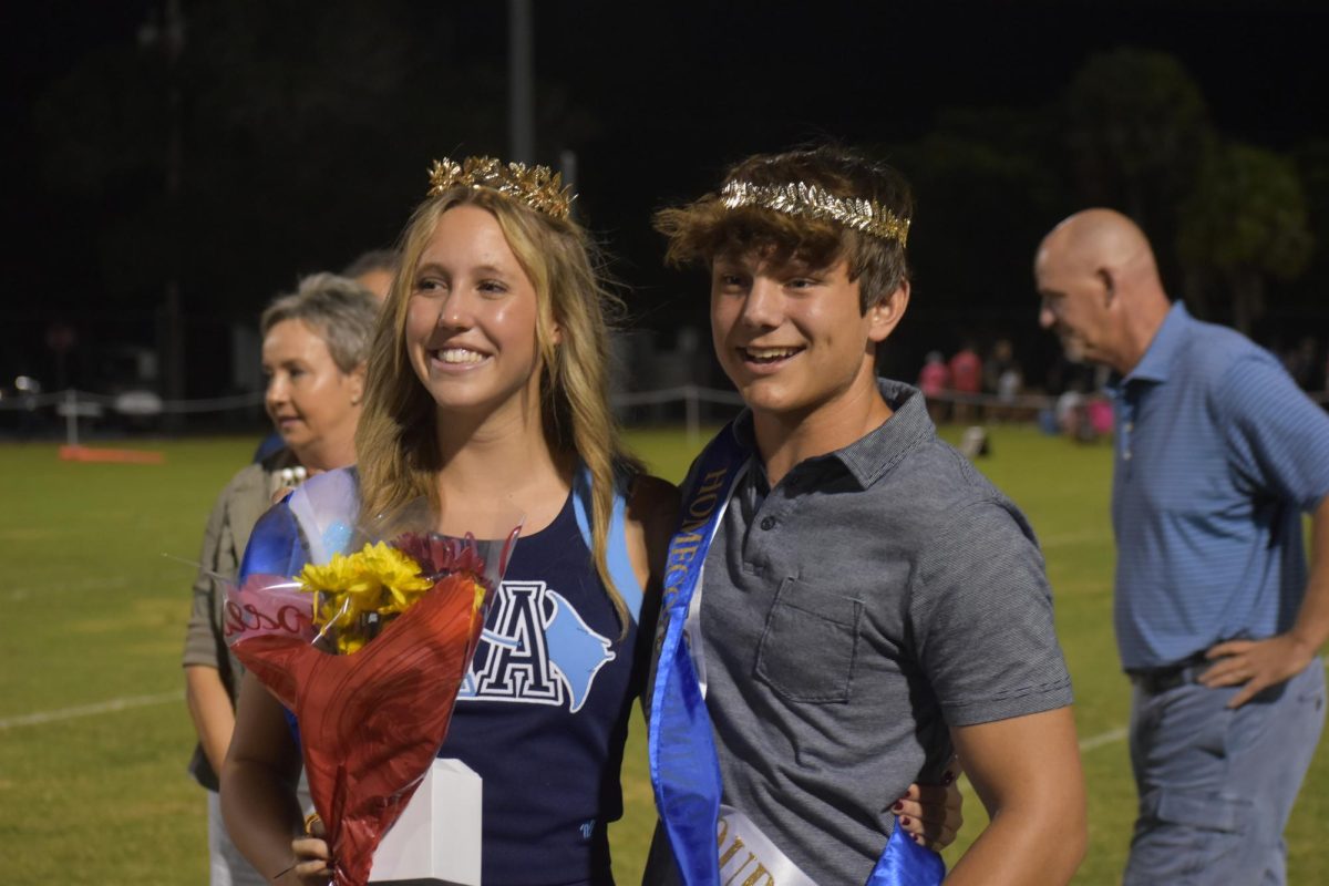 Homecoming king and queen, Chase Johnson and Collette Combs smiling after their win. 