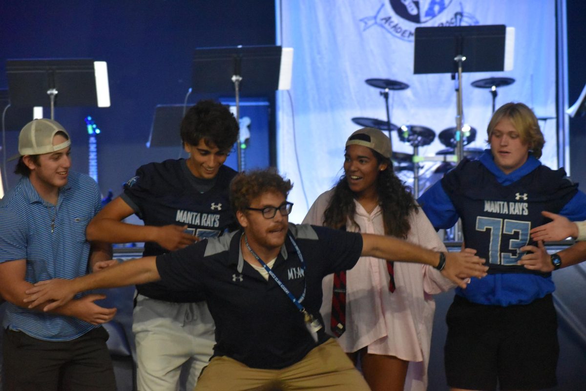 Mr. Ginther blocking students from passing him in one of the games. 