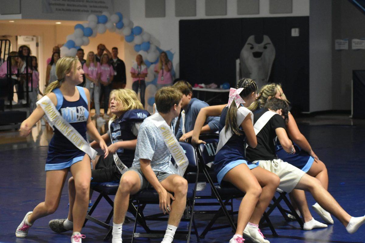 The Homecoming court playing a competitive game of musical chairs.