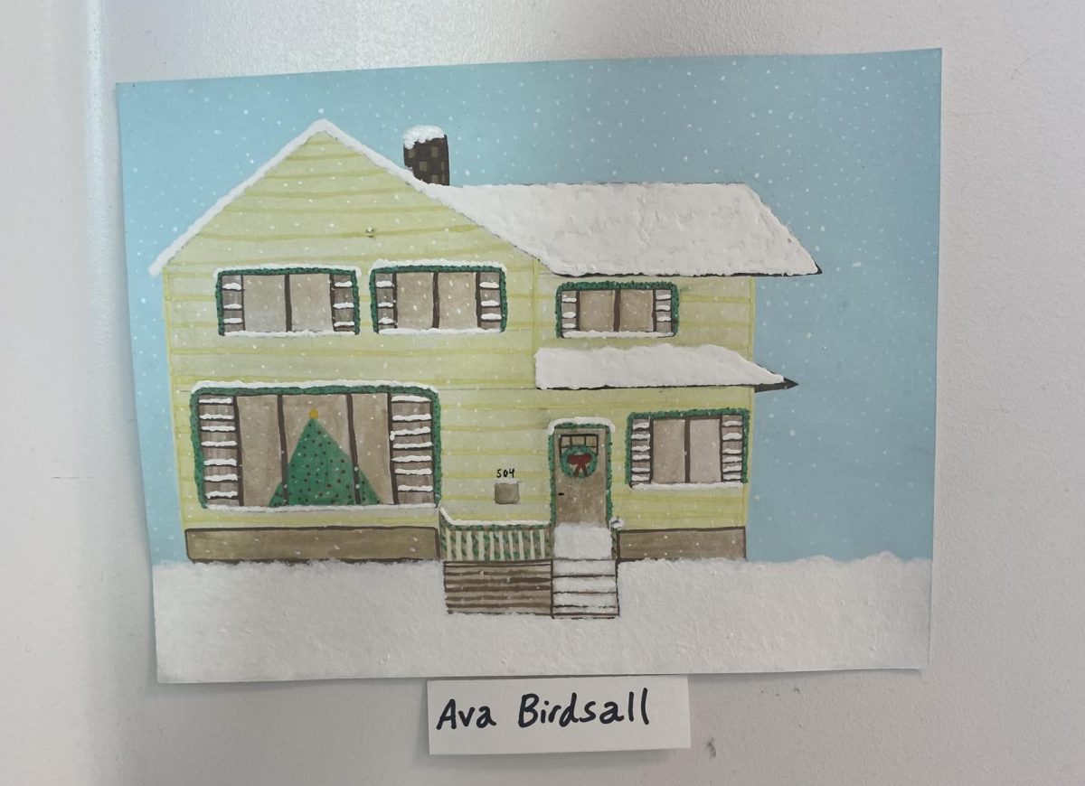 A festive house covered in snow with decorated with some holiday cheer.