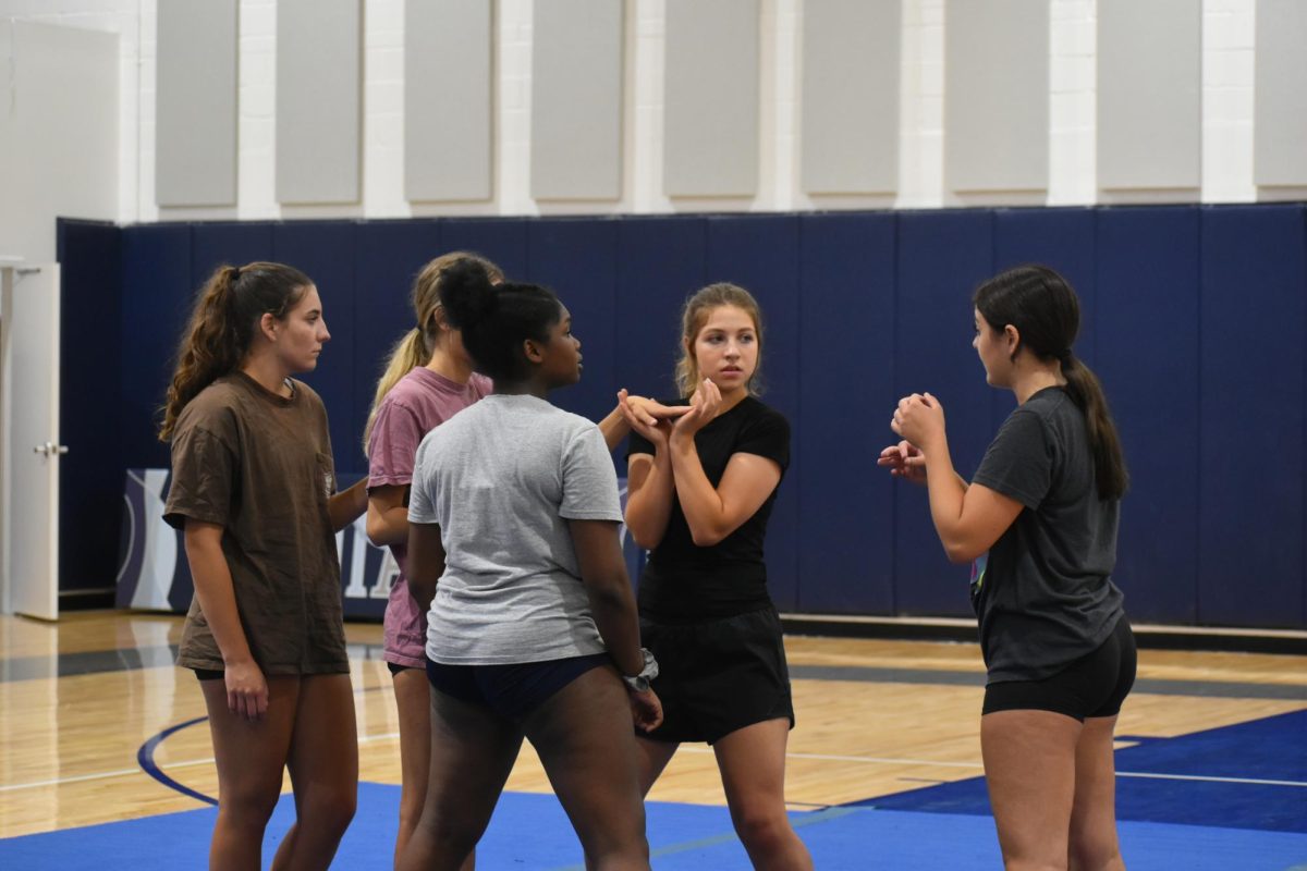 Cassie Letendre teaches a stunt group how to do a prep stunt.