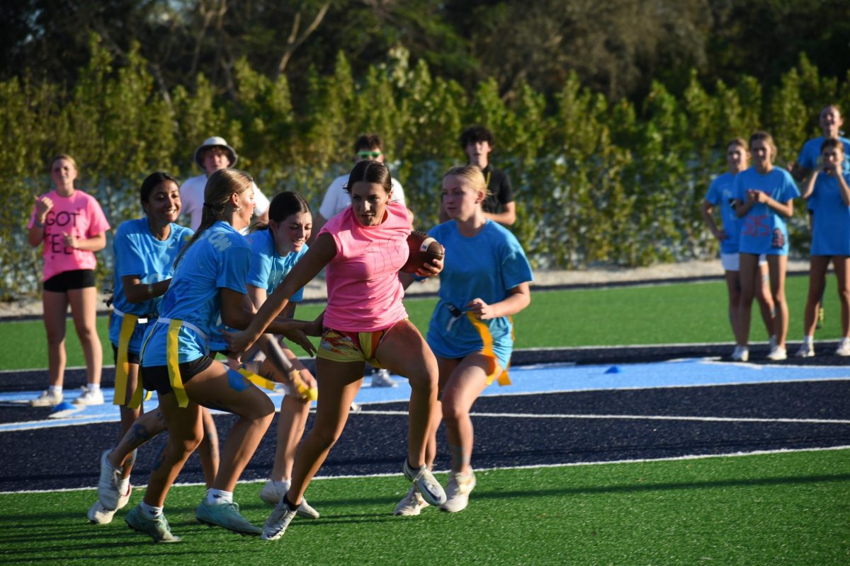 Mary Montgomery getting surrounded by the blue team but shows perseverance and does not give up.