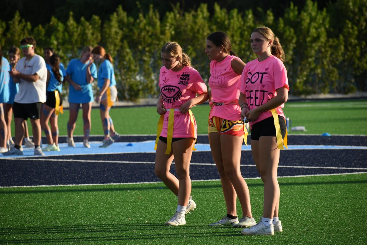 Lucy McFarland, Mary Montgomery, and Celeste Forester making a game plan to defeat the blue team.