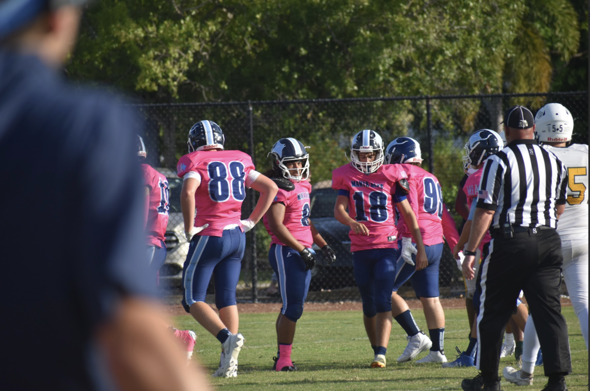 Senior Noah Smith, number 8, looking towards defensive coach Luke Evangelista for direction.