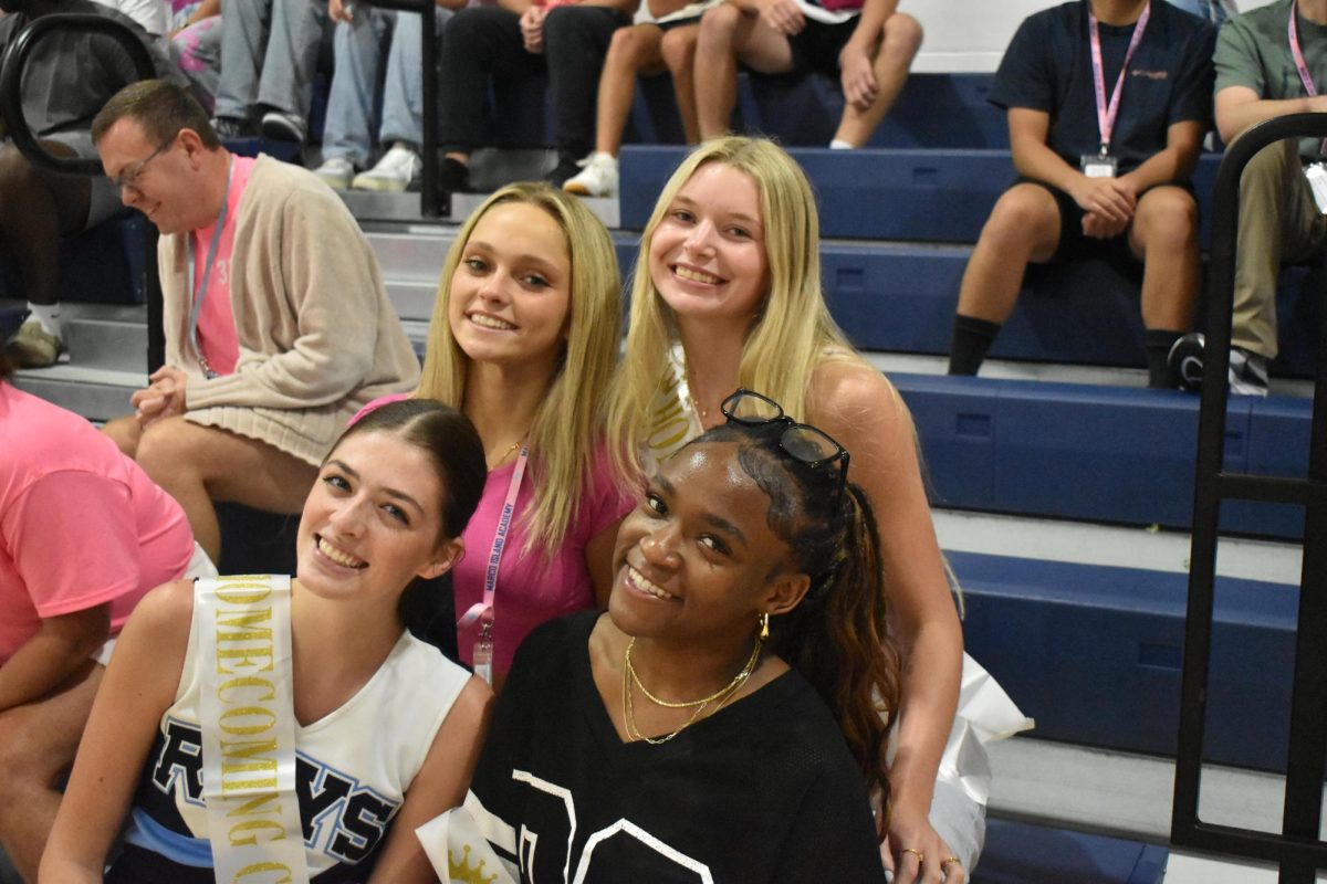Seniors Lily Chiscavage, Medney Garraux, Rylee Howard, and Madie Stolinas enjoy the pep rally from the bleachers.