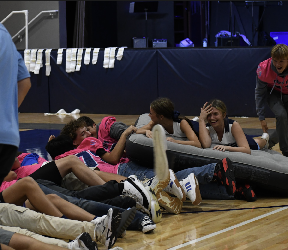 Cheerleaders and football players participating in the game 'Get the Princess to her Tower'