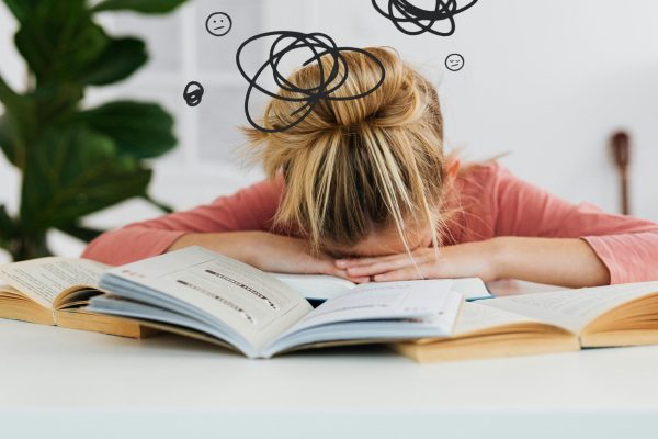 Woman Putting Her Head Down on the Desk. (Photo by: Kaboompics.com)