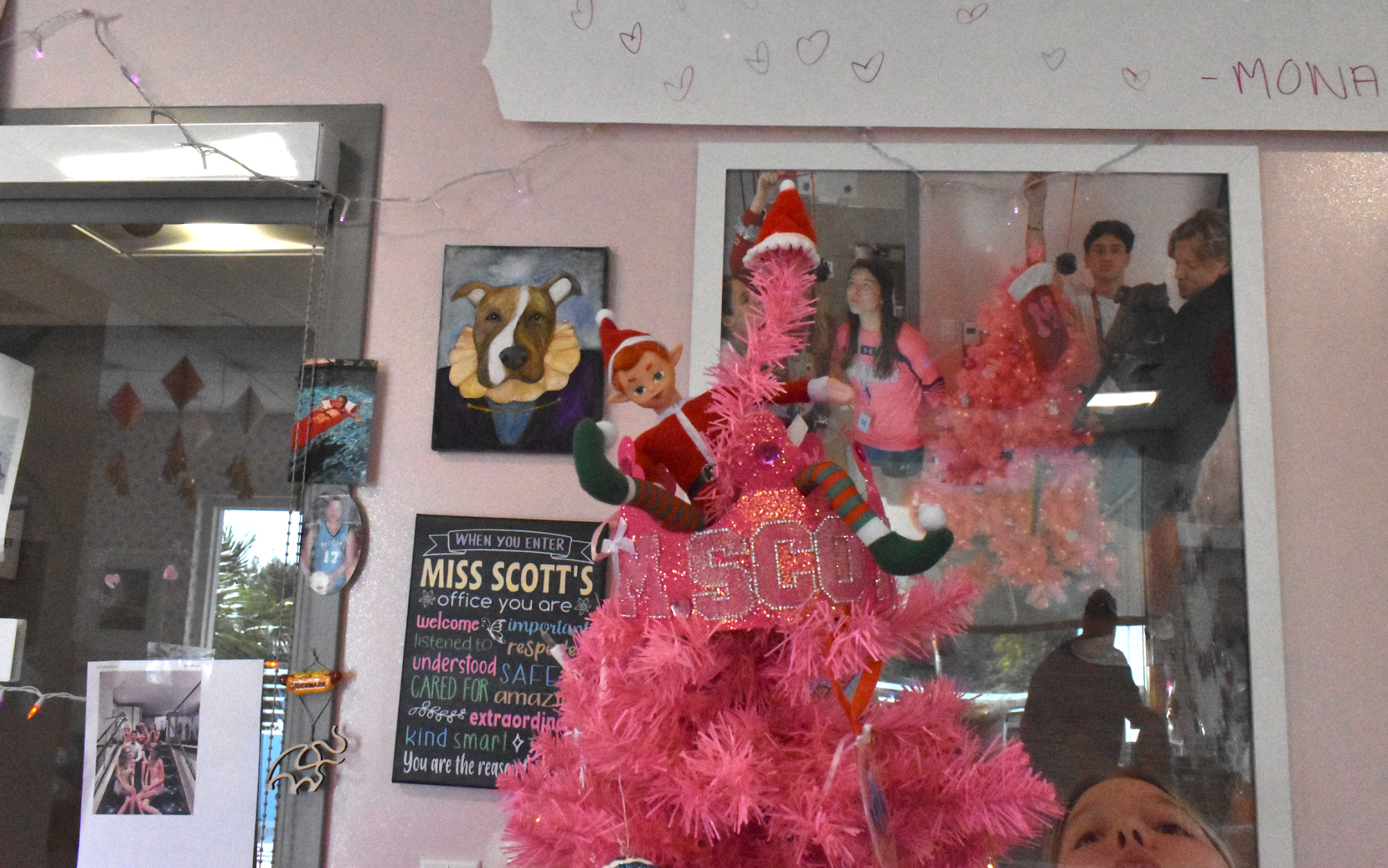 Irwin the Elf sitting on top of a Christmas tree. 