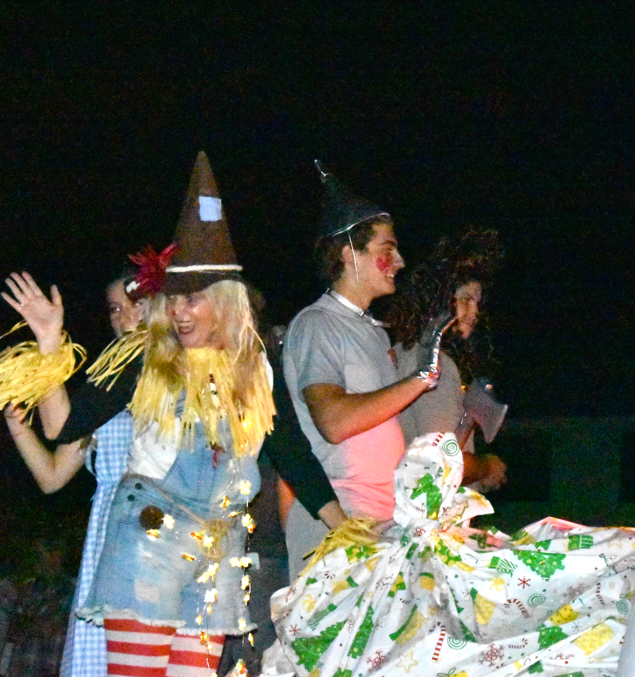 Miss Scott waves to the children in the crowd as the MIA truck travels further down the road.