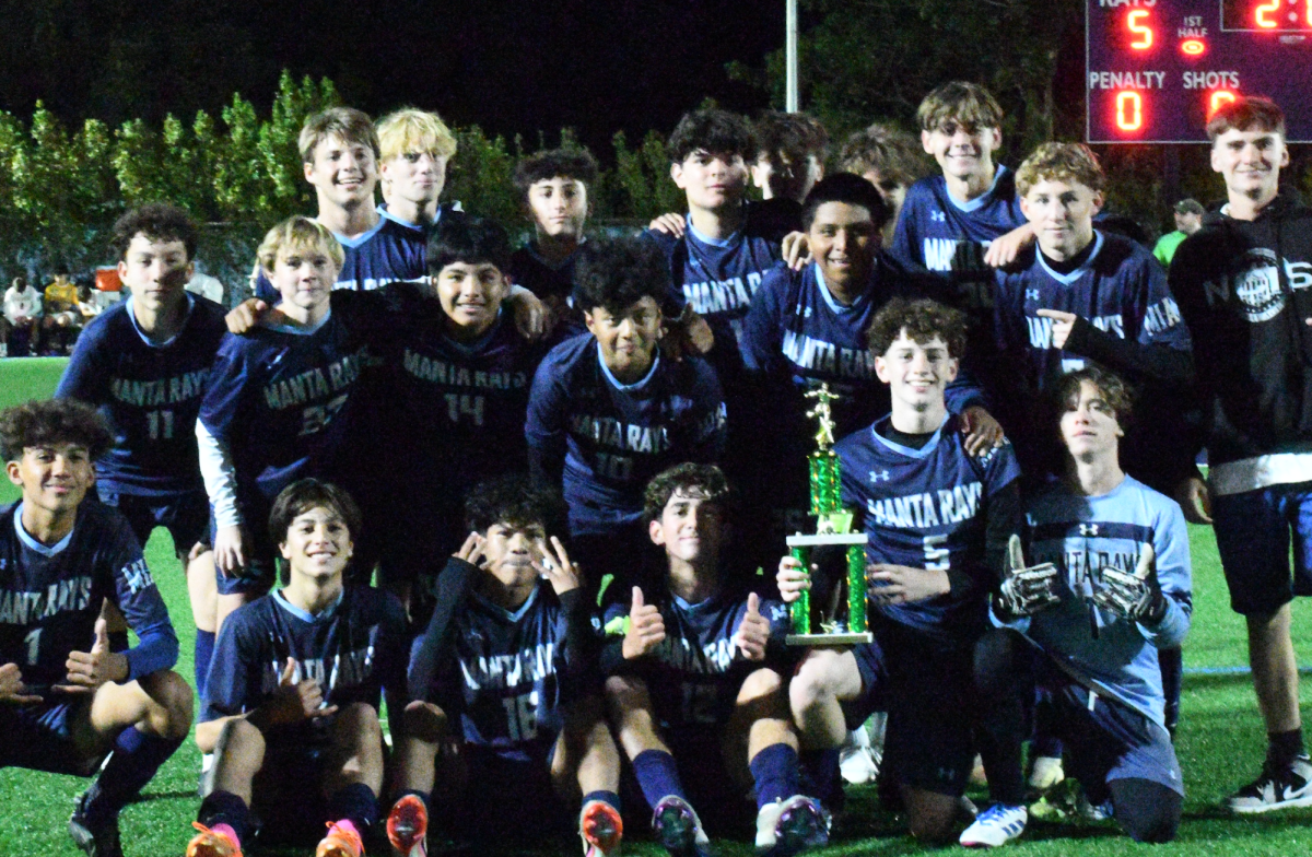 The soccer boys posing together with the PCAC trophy. 