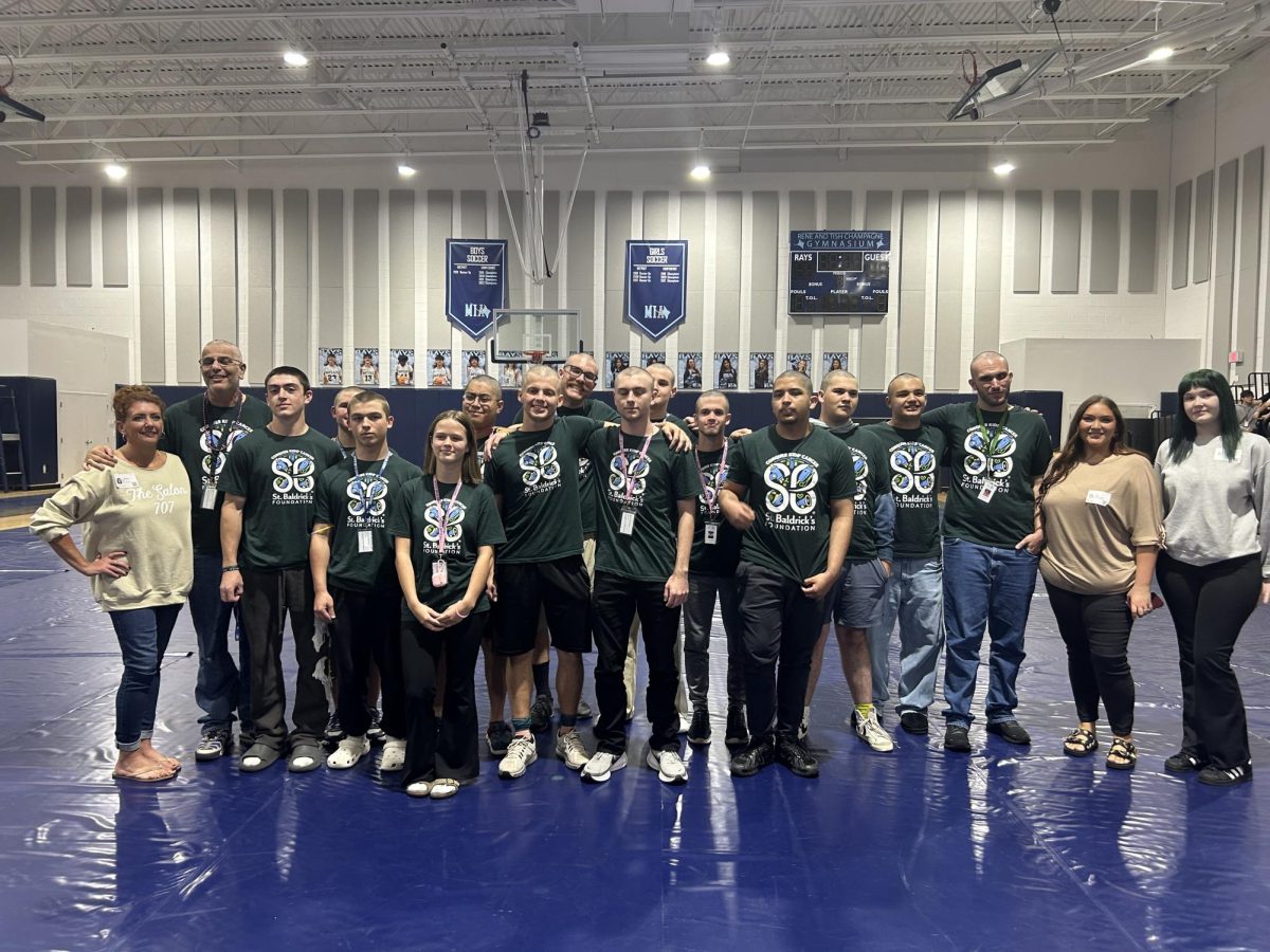 All of the Saint Baldrick's shavees posing together with the barbers for a final photo.