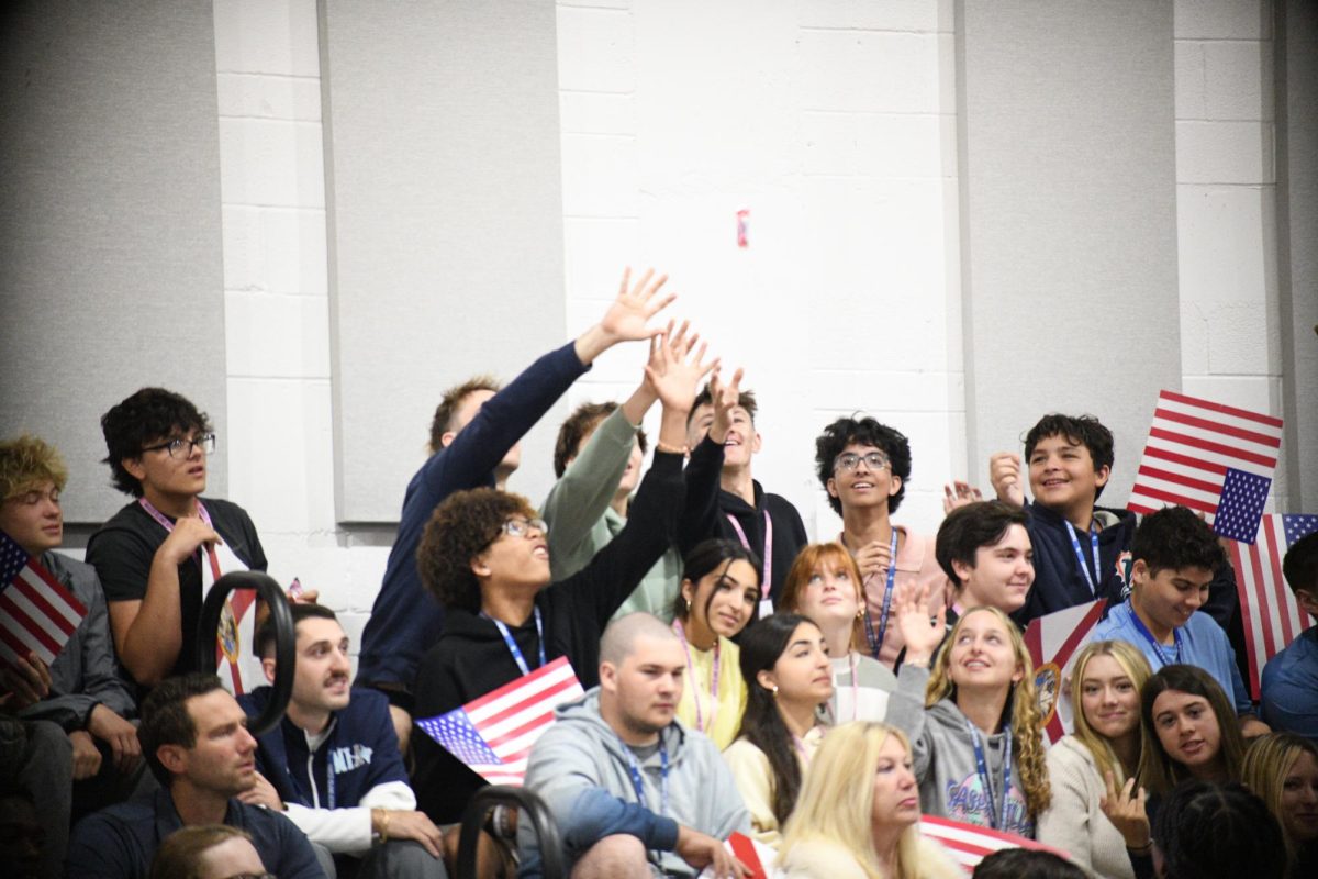 Students in the crowd reaching to grab History Rocks! swag.