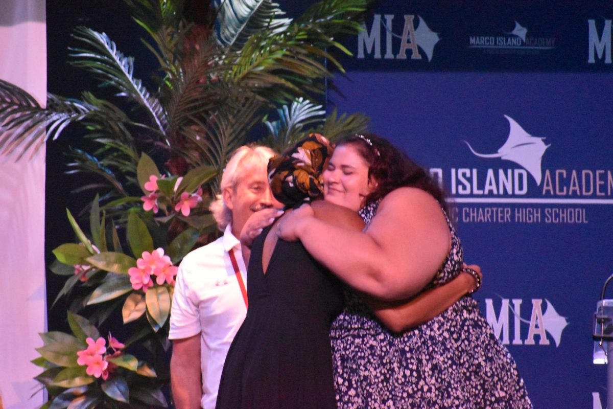 Kai Samuel hugging Ms. Pisculli while being given the Art Department Award.